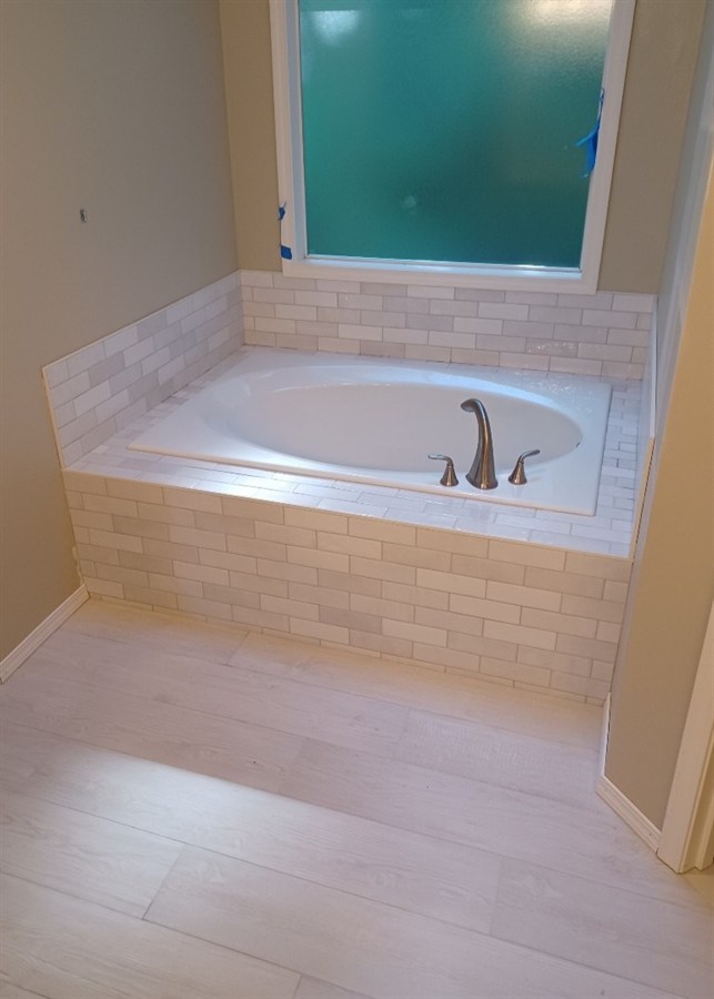 White subway tile tub surround and deck