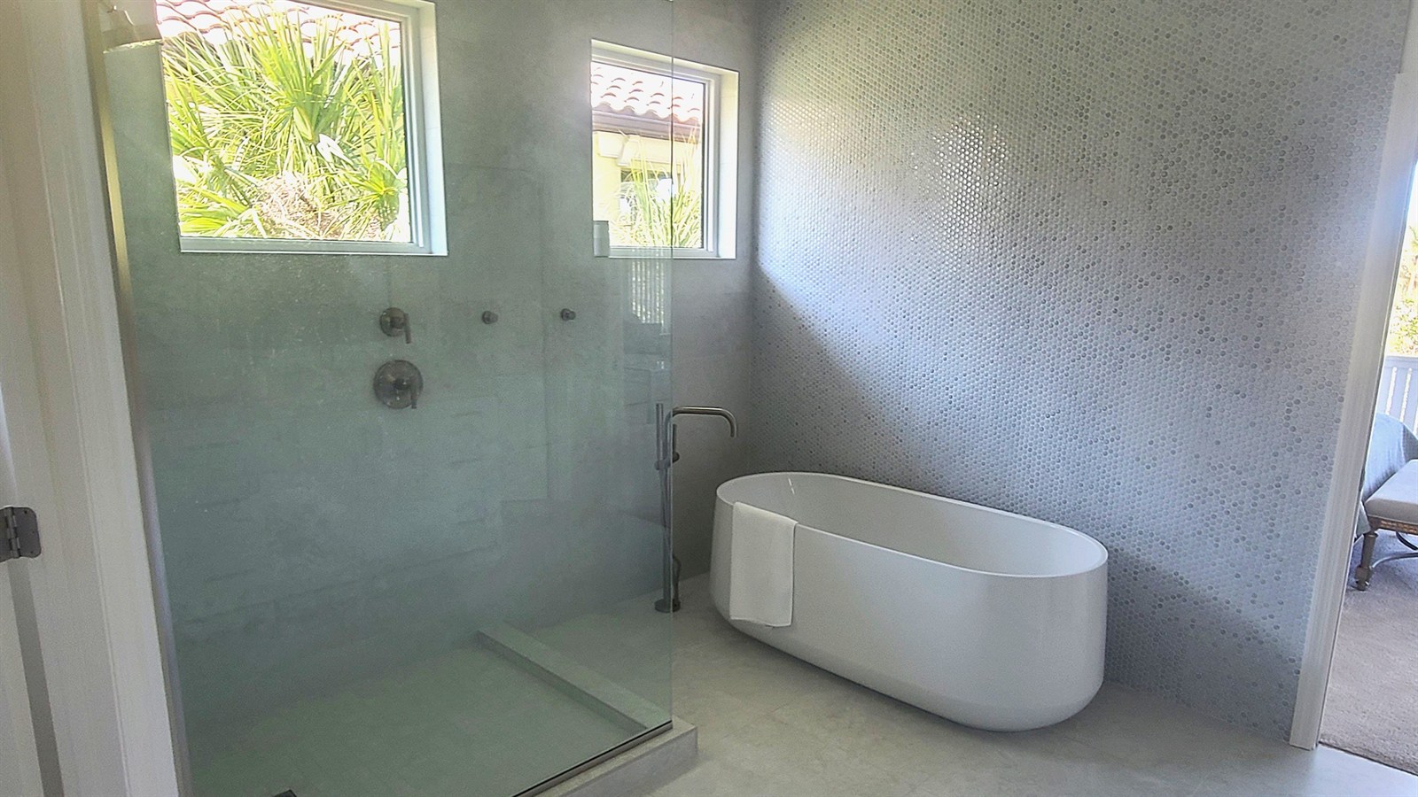 Custom tile shower and freestanding tub in a newly remodeled bathroom