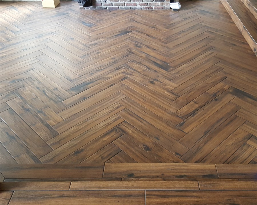 Herringbone wood-look plank tile flooring