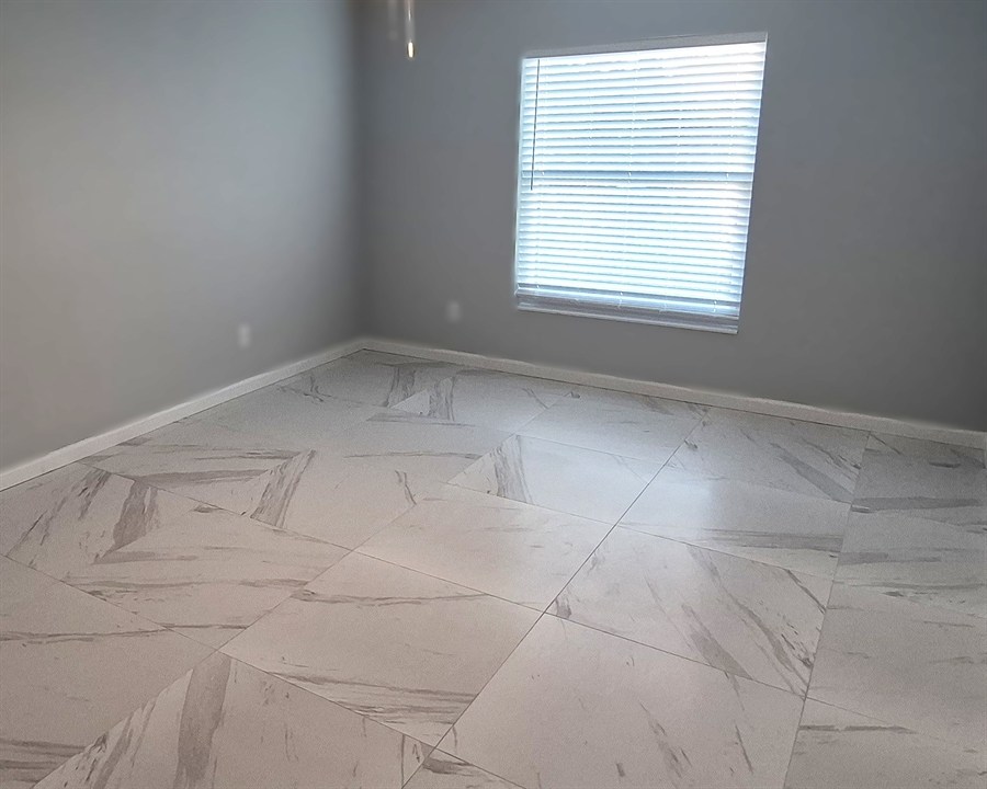 Large-format marble-look porcelain tile flooring