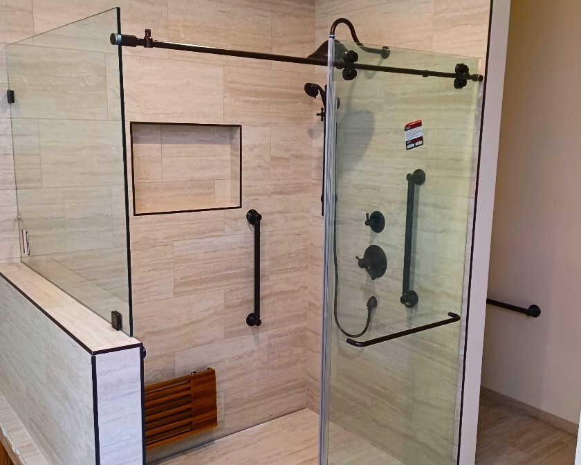 Subway tile shower with built-in bench and arched window